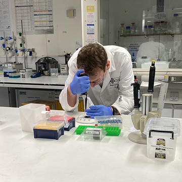 Dr John Walsby-Tickle pipetting onto a MALDI target plate